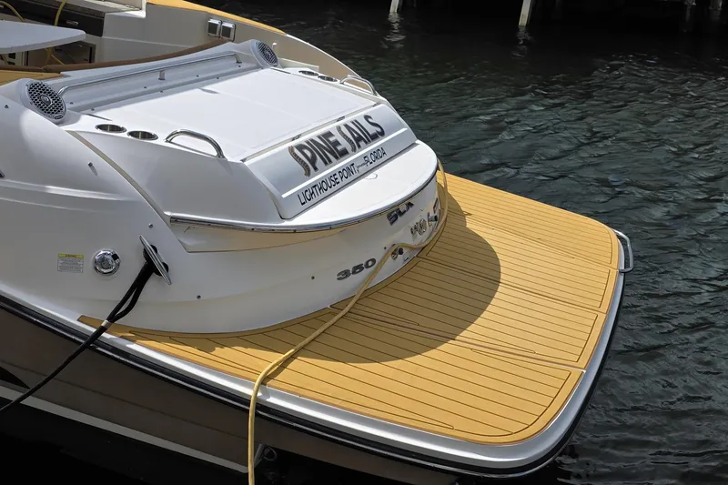 Slide: The Image of 2015 Sea Ray SLX 350 boat docked, featuring a spacious swim platform. - 4