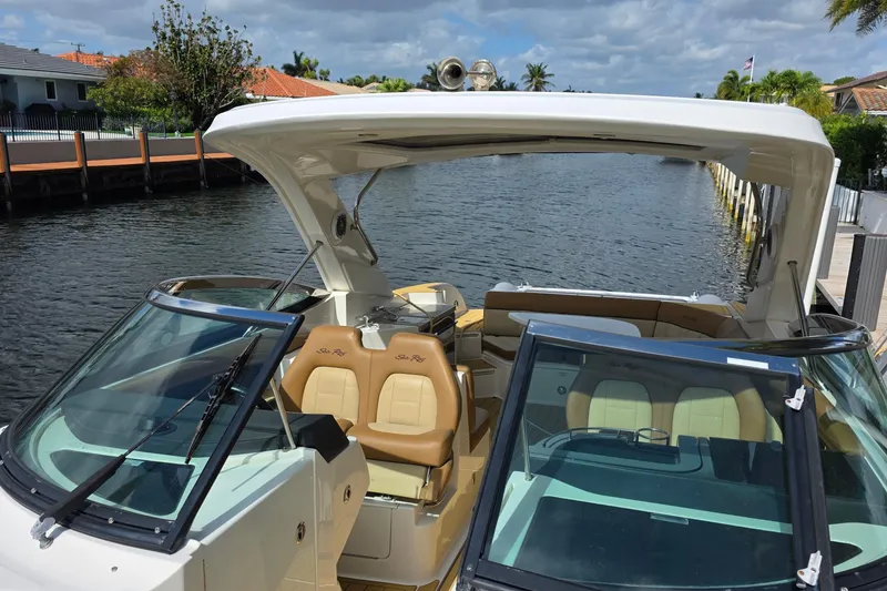 Slide: The Image of 2015 Sea Ray SLX 350 boat docked on a sunny day, showcasing luxurious seating. - 42