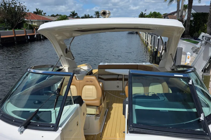 Slide: The Image of 2015 Sea Ray SLX 350 boat with open deck, docked by a canal. - 43