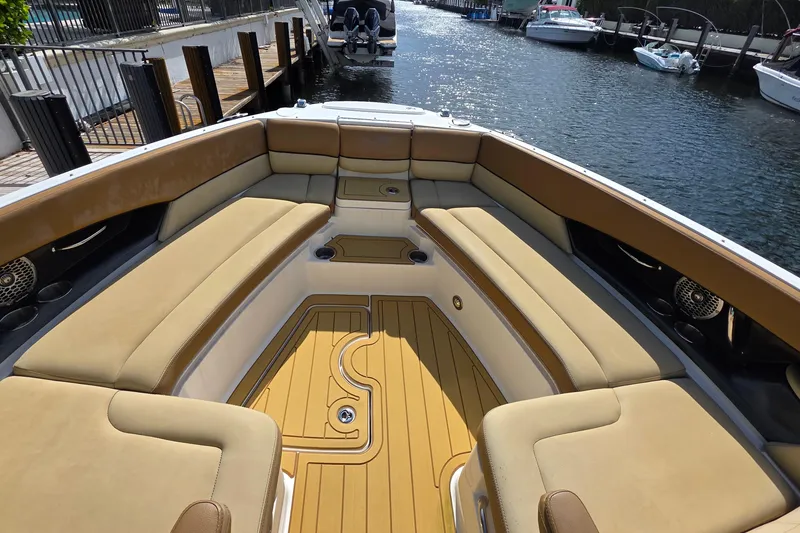 Slide: The Image of Luxurious seating area on a 2015 Sea Ray SLX 350 boat, docked by the water. - 45