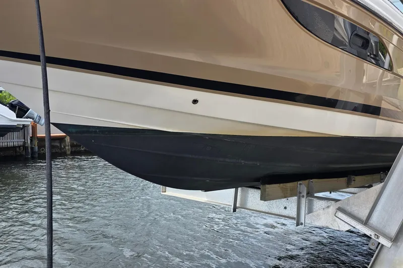 Slide: The Image of 2015 Sea Ray SLX 350 boat on lift, partially above water. - 7