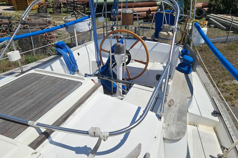 Slide: The Image of 1979 Morgan 382 sailboat cockpit with wooden steering wheel and blue rigging. - 16