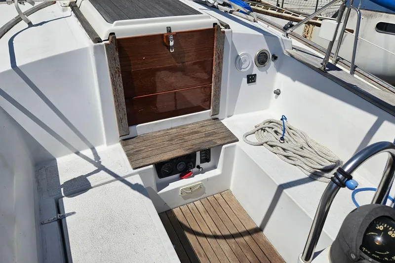 Slide: The Image of Cockpit of 1979 Morgan 382 sailboat with wooden hatch and coiled rope. - 19
