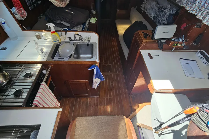 Slide: The Image of Interior of a 1979 Morgan 382 sailboat with kitchen and navigation area. - 24