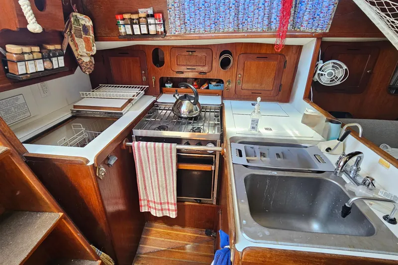 Slide: The Image of 1979 Morgan 382 yacht kitchen with stove, sink, and spice rack. - 26