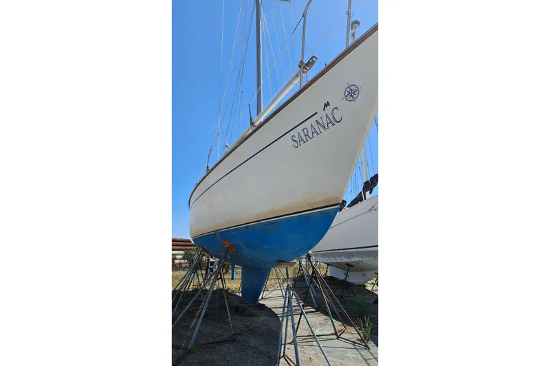 Slide: The Image of 1979 Morgan 382 sailboat named "Saranac" on stands, viewed from below. - 3