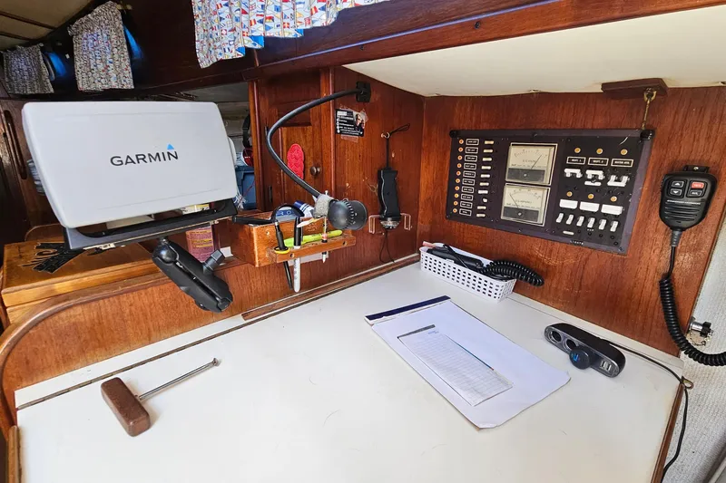 Slide: The Image of Navigation station in a 1979 Morgan 382 sailboat with Garmin equipment and control panel. - 33