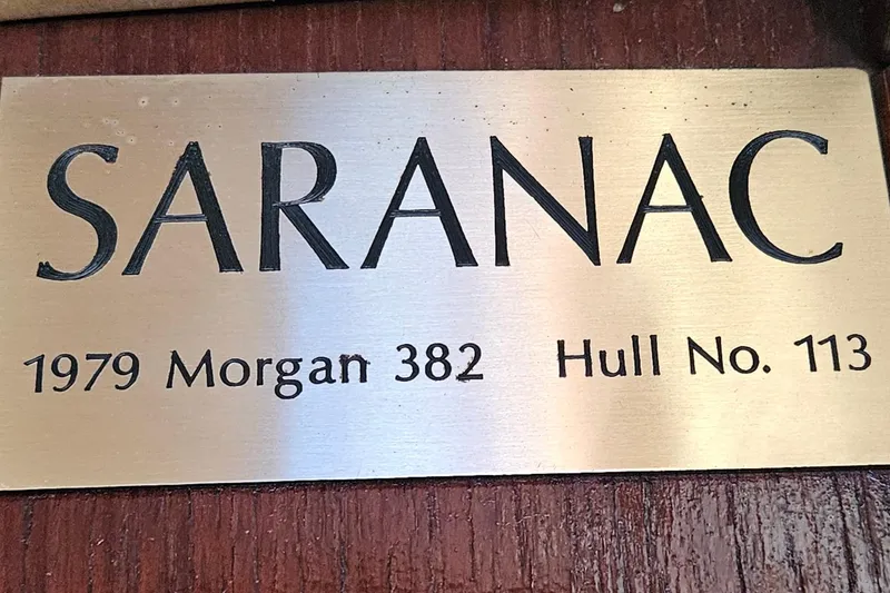 Slide: The Image of Plaque displaying "SARANAC," 1979 Morgan 382, Hull No. 113, on a wooden background. - 39