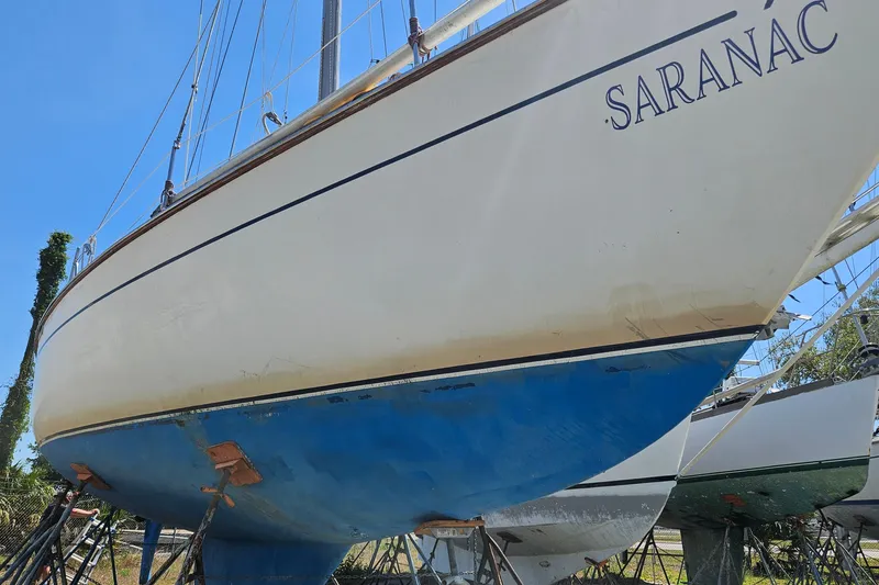 Slide: The Image of 1979 Morgan 382 sailboat named "Saranac" on dry dock, showcasing its blue hull. - 4