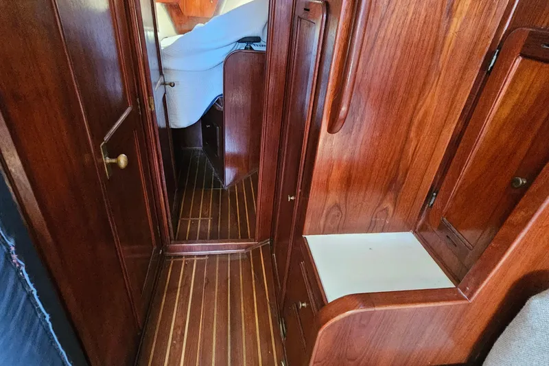 Slide: The Image of Interior of a 1979 Morgan 382 sailboat with wooden cabinetry and flooring. - 40