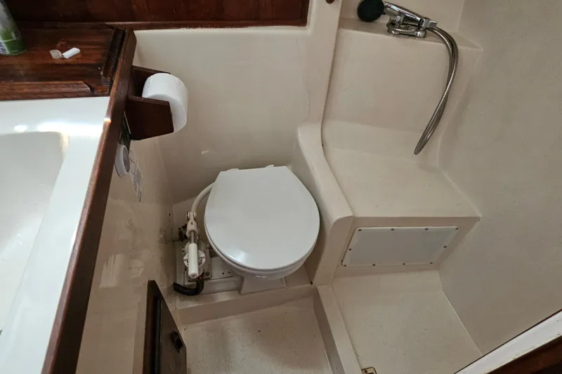 Slide: The Image of 1979 Morgan 382 yacht bathroom with toilet, shower, and wooden accents. - 41