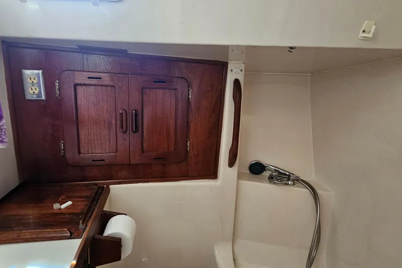 Slide: The Image of 1979 Morgan 382 yacht interior with wooden cabinet and showerhead. - 42