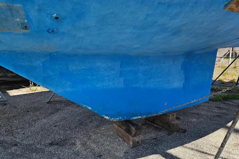 Slide: The Image of Blue hull of a 1979 Morgan 382 sailboat on dry dock. - 46
