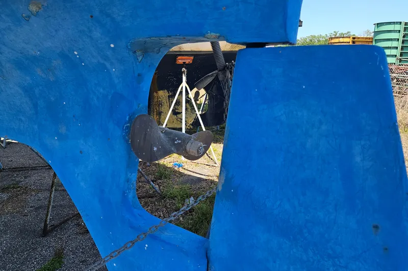 Slide: The Image of Close-up of a 1979 Morgan 382 sailboat's blue hull and propeller in a boatyard. - 47
