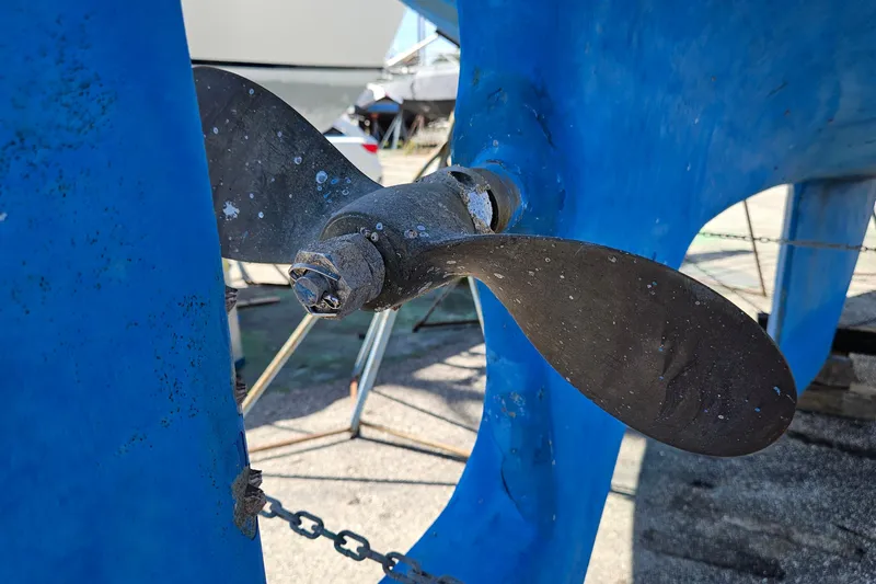 Slide: The Image of Close-up of a 1979 Morgan 382 sailboat propeller with blue hull background. - 48