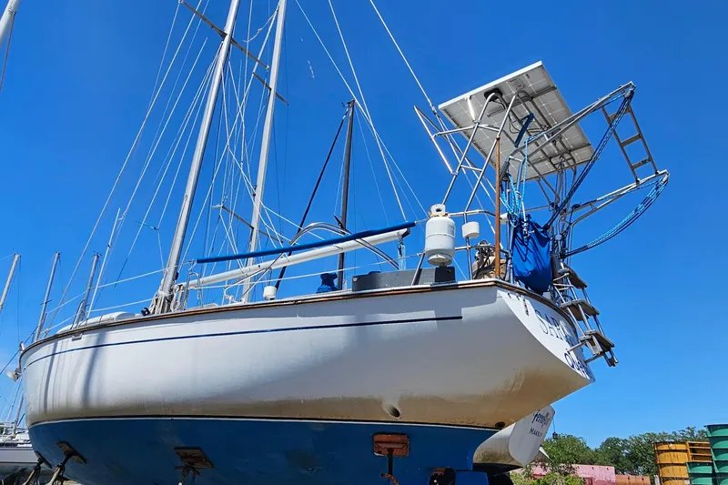 Slide: The Image of 1979 Morgan 382 sailboat on land, blue sky background, solar panels visible. - 6