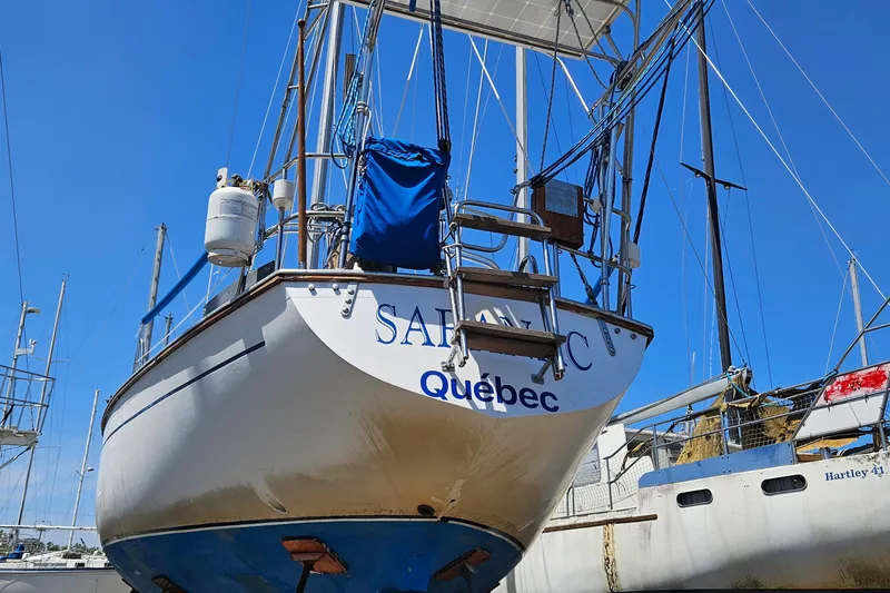 Slide: The Image of 1979 Morgan 382 sailboat named "Satanic" from Quebec, docked in a marina. - 7
