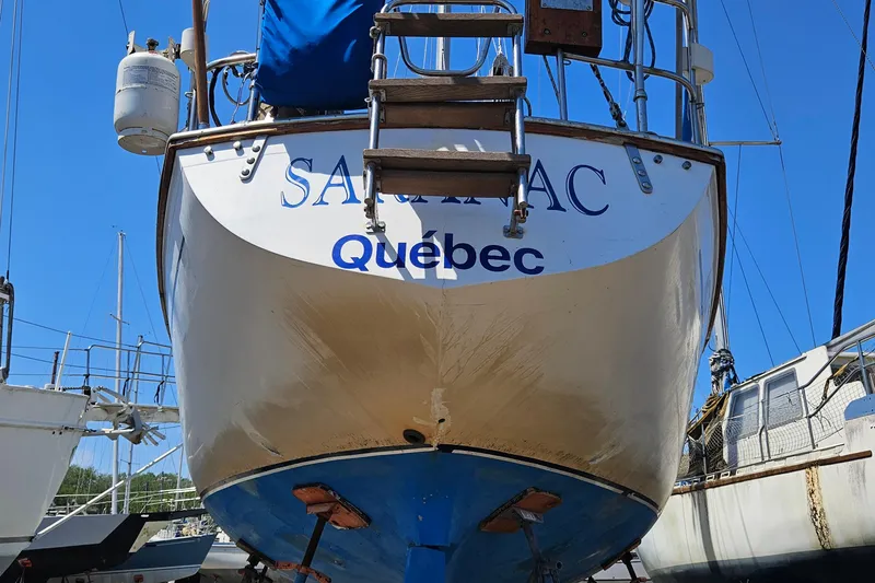 Slide: The Image of 1979 Morgan 382 sailboat named "Saranac" from Quebec, docked in a marina. - 9