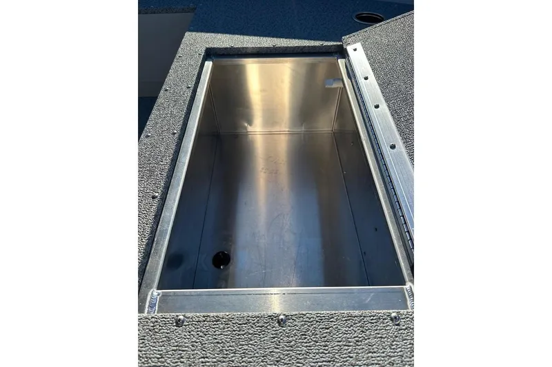 Slide: The Image of Open storage compartment in 2026 Smoker Craft Angler 16 SC boat. - 13
