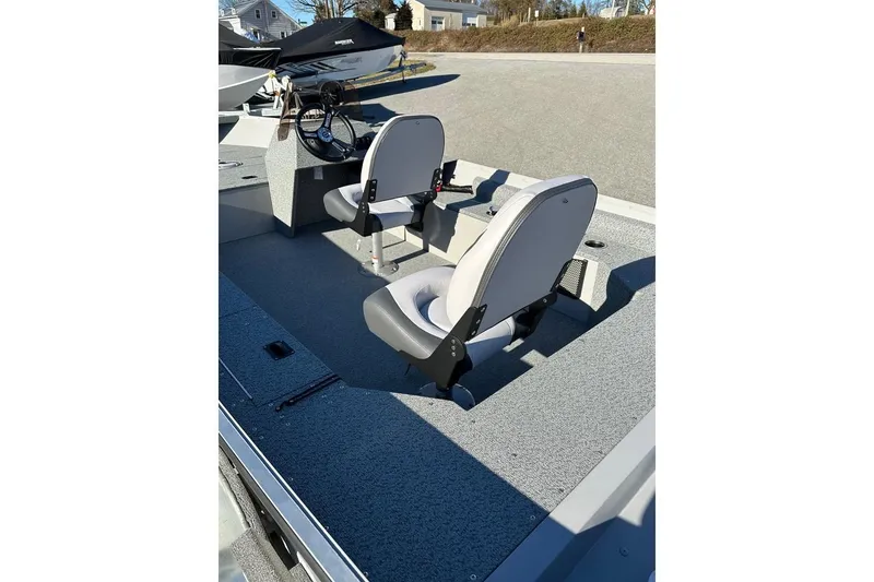 Slide: The Image of 2026 Smoker Craft Angler 16 SC boat interior with two seats and steering console. - 5