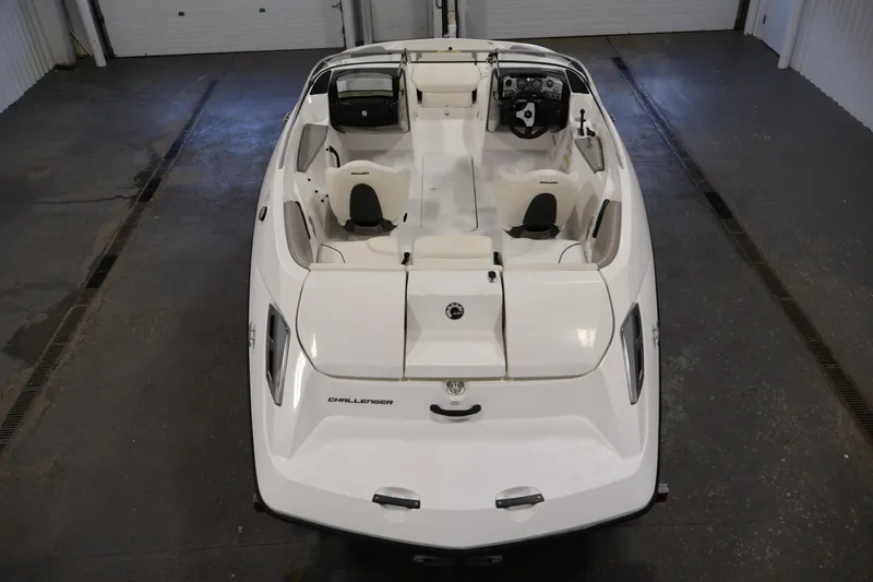Slide: The Image of 2011 Sea-Doo Challenger 180 boat, white interior, overhead view in a garage setting. - 10