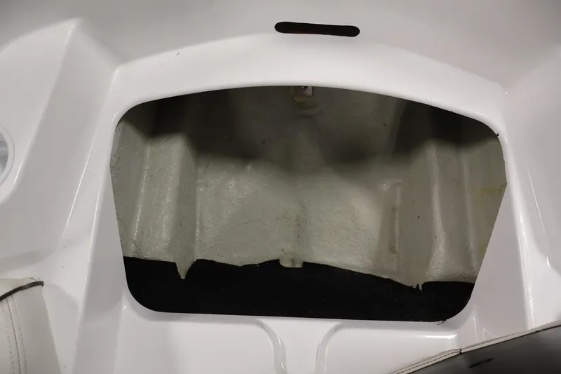 Slide: The Image of 2011 Sea-Doo Challenger 180 storage compartment, white interior, open hatch view. - 14