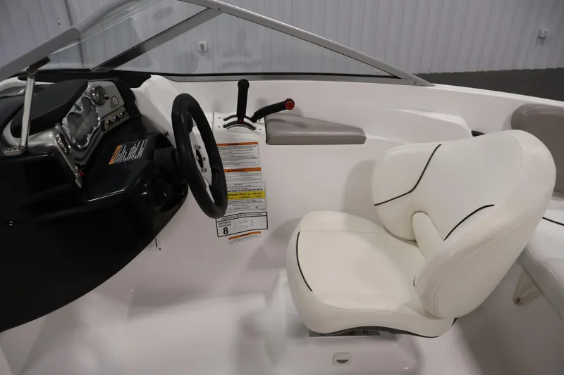 Slide: The Image of 2011 Sea-Doo Challenger 180 cockpit with steering wheel and white captain's chair. - 16