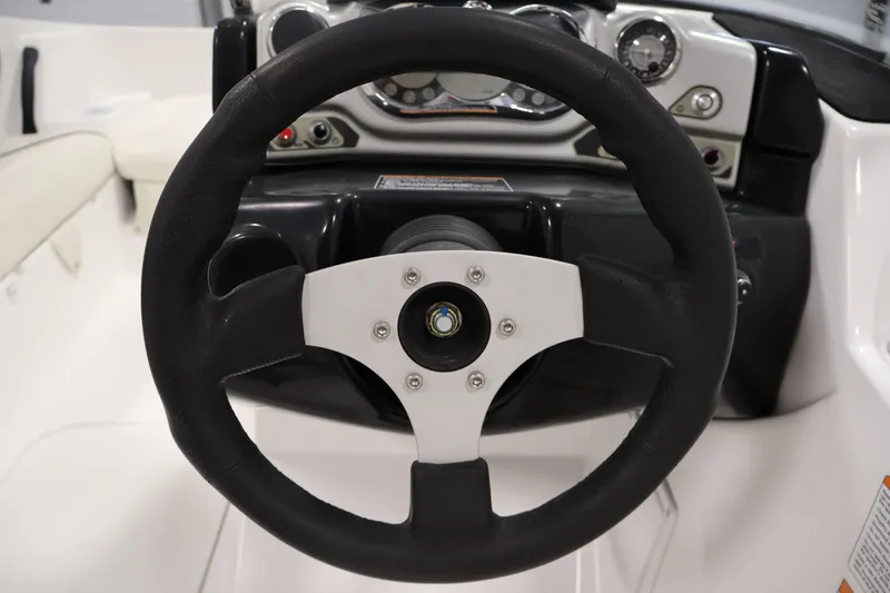 Slide: The Image of Steering wheel of 2011 Sea-Doo Challenger 180 boat, featuring dashboard controls. - 18