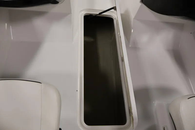 Slide: The Image of 2011 Sea-Doo Challenger 180 boat interior storage compartment with white seating. - 26