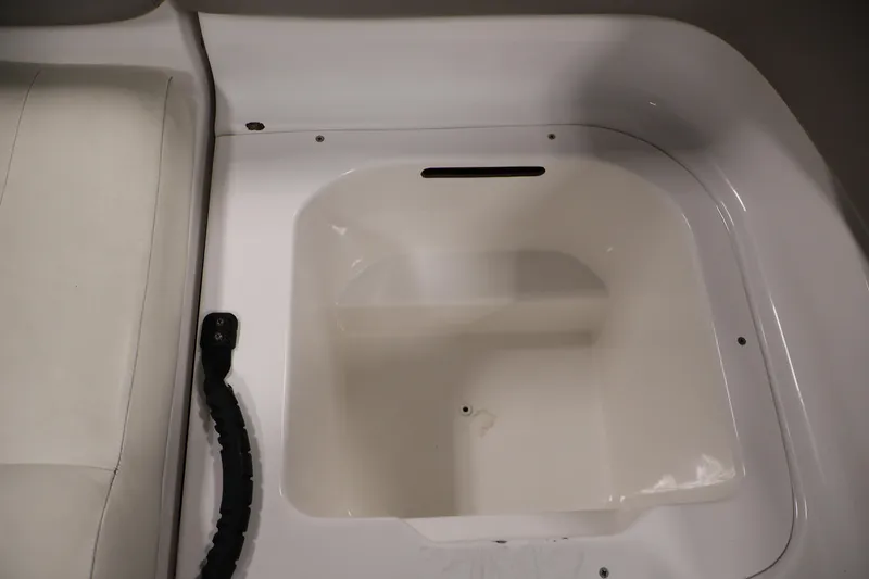 Slide: The Image of 2011 Sea-Doo Challenger 180 storage compartment with white interior and adjacent seating. - 28
