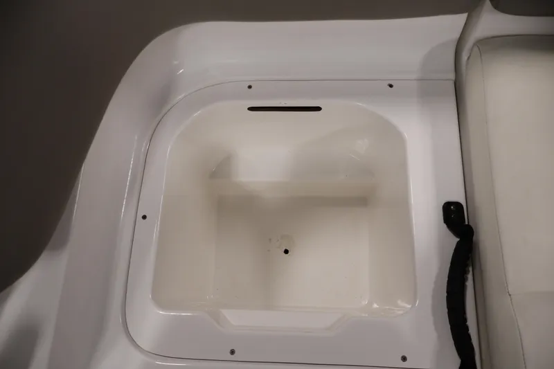 Slide: The Image of Storage compartment of 2011 Sea-Doo Challenger 180 boat, featuring a white interior. - 29