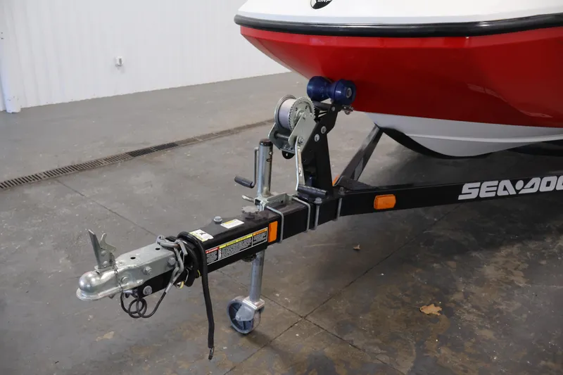 Slide: The Image of 2011 Sea-Doo Challenger 180 boat on trailer, featuring red and white hull. - 33