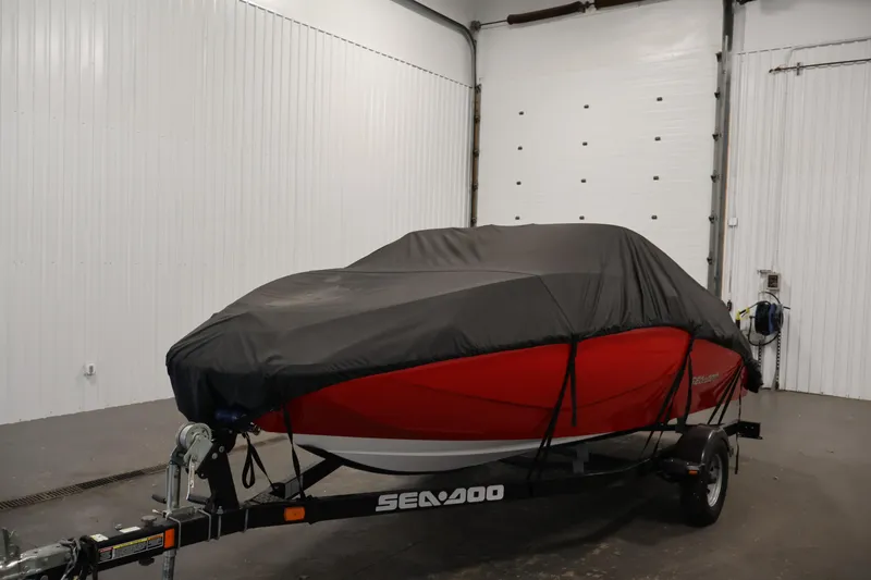 Slide: The Image of 2011 Sea-Doo Challenger 180 boat covered in a garage on a trailer. - 36
