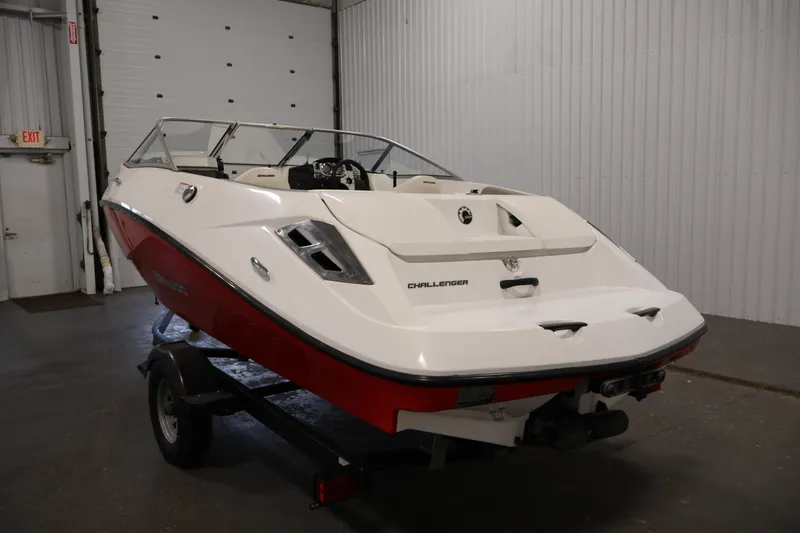 Slide: The Image of 2011 Sea-Doo Challenger 180 boat in a garage, featuring a sleek white and red design. - 7