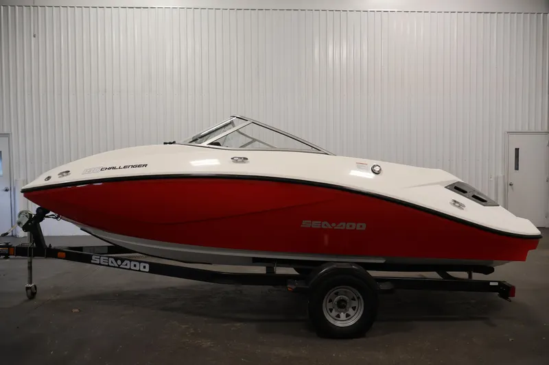 Slide: The Image of 2011 Sea-Doo Challenger 180 boat with red and white design on trailer. - 8