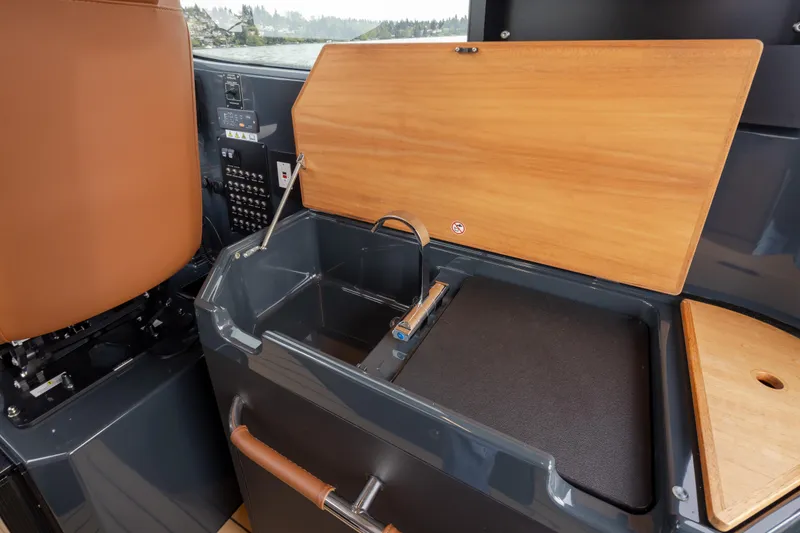 Slide: The Image of Interior of 2023 Arksen 30 Adventure boat featuring a compact kitchenette with sink and wooden accents. - 12