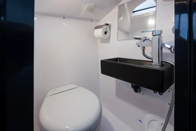 Slide: The Image of Modern bathroom in 2023 Arksen 30 Adventure boat, featuring sleek sink and toilet design. - 13