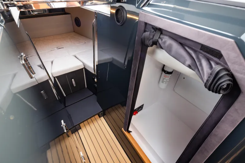 Slide: The Image of Interior of 2023 Arksen 30 Adventure boat, featuring cabin and storage area. - 15