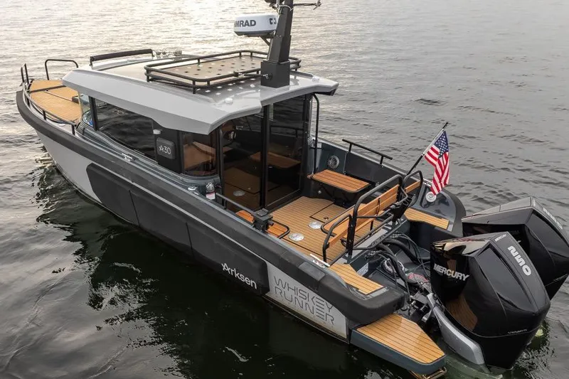 Slide: The Image of 2023 Arksen 30 Adventure boat on water, featuring sleek design and dual Mercury engines. - 19