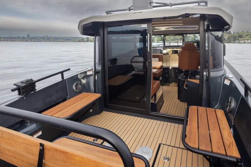 Slide: The Image of 2023 Arksen 30 Adventure boat interior with wooden seating and modern design on a calm lake. - 26