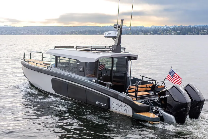 Slide: The Image of 2023 Arksen 30 Adventure boat cruising on a lake with American flag. - 28