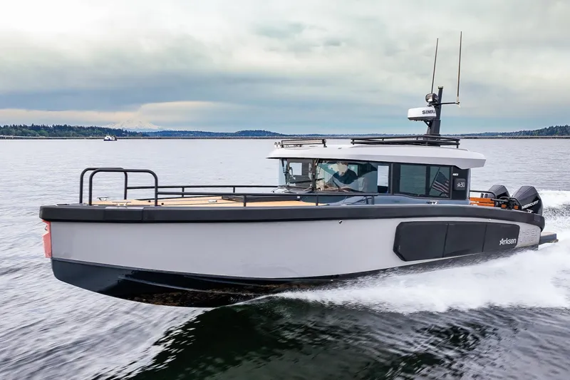 Slide: The Image of 2023 Arksen 30 Adventure boat cruising on a calm lake under cloudy skies. - 3