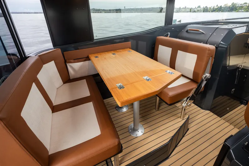 Slide: The Image of Interior of 2023 Arksen 30 Adventure boat with cozy seating and wooden table. - 5