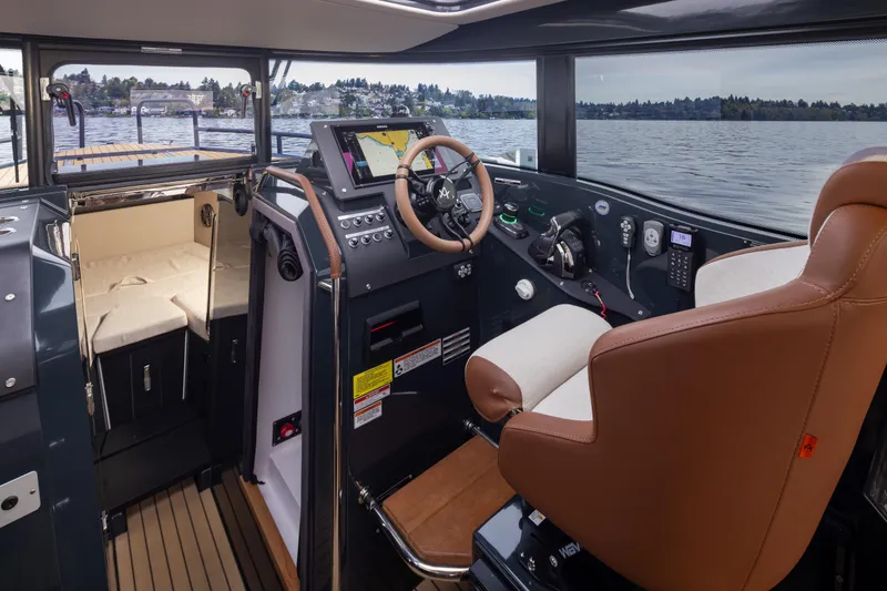 Slide: The Image of Interior of 2023 Arksen 30 Adventure boat with modern controls and seating. - 9