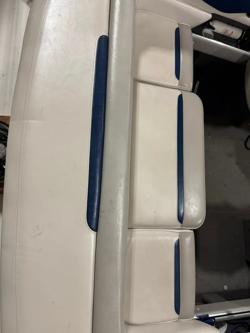 Slide: The Image of Interior of a 1995 Four Winns 245 Sundowner boat, white upholstery with blue accents. - 3