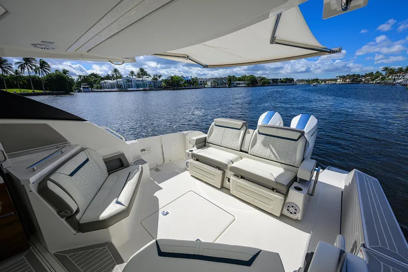 Slide: The Image of Luxurious 2022 Tiara Yachts 43 LE with elegant seating, overlooking serene waterfront views. - 10