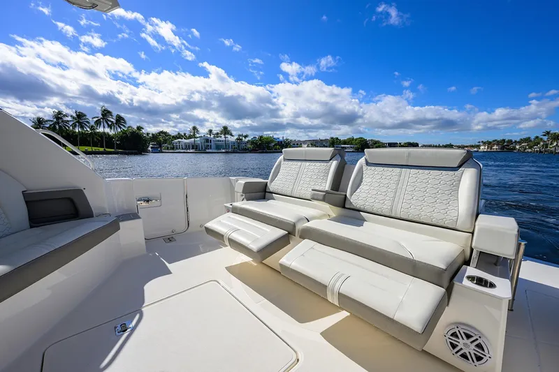 Slide: The Image of Luxurious seating on 2022 Tiara Yachts 43 LE, overlooking serene waterfront and blue sky. - 12