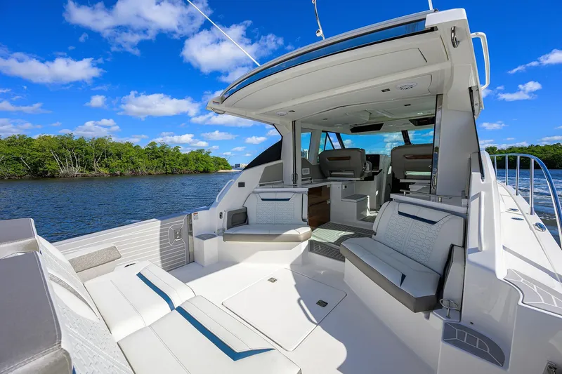 Slide: The Image of 2022 Tiara Yachts 43 LE luxury yacht interior with seating, on a sunny day. - 16