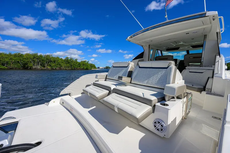 Slide: The Image of 2022 Tiara Yachts 43 LE luxury yacht with spacious seating, cruising on a sunny day. - 17