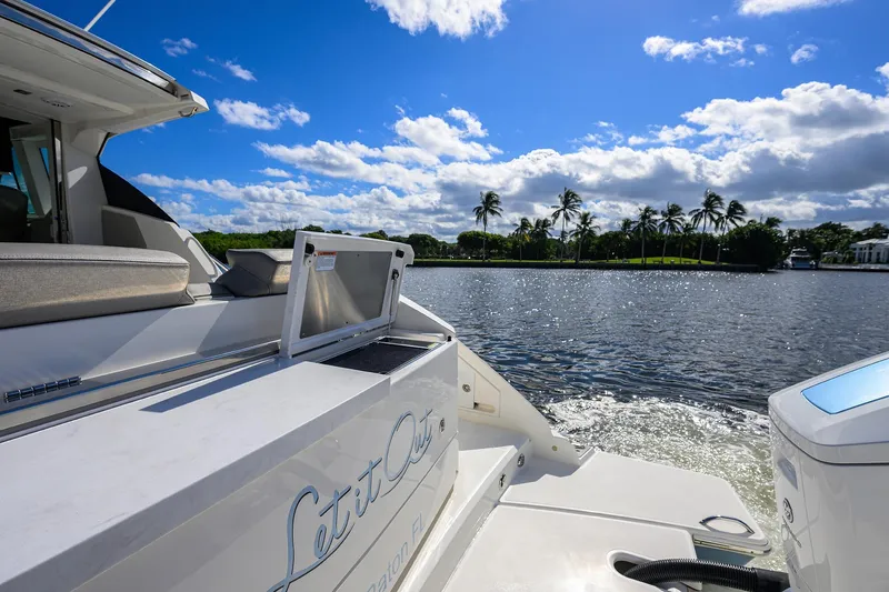 Slide: The Image of 2022 Tiara Yachts 43 LE on water, sunny day, palm trees in background. - 18